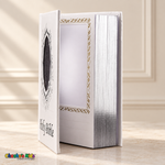 Open white English Holy Bible showing its inner photo pocket, gold scroll border and silver page edges.