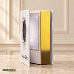 Small Spanish Holy Bible with white hardcover and gold-tone details, open to show the interior photo pocket and reflective page edges