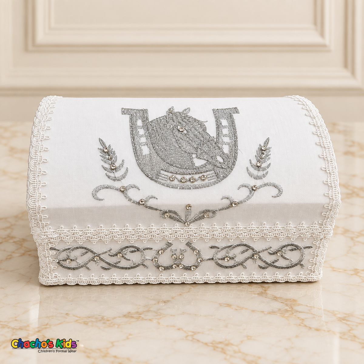 Closed white baptism keepsake chest with silver horse-and-horseshoe embroidery, scroll details, rhinestones and white braid trim.