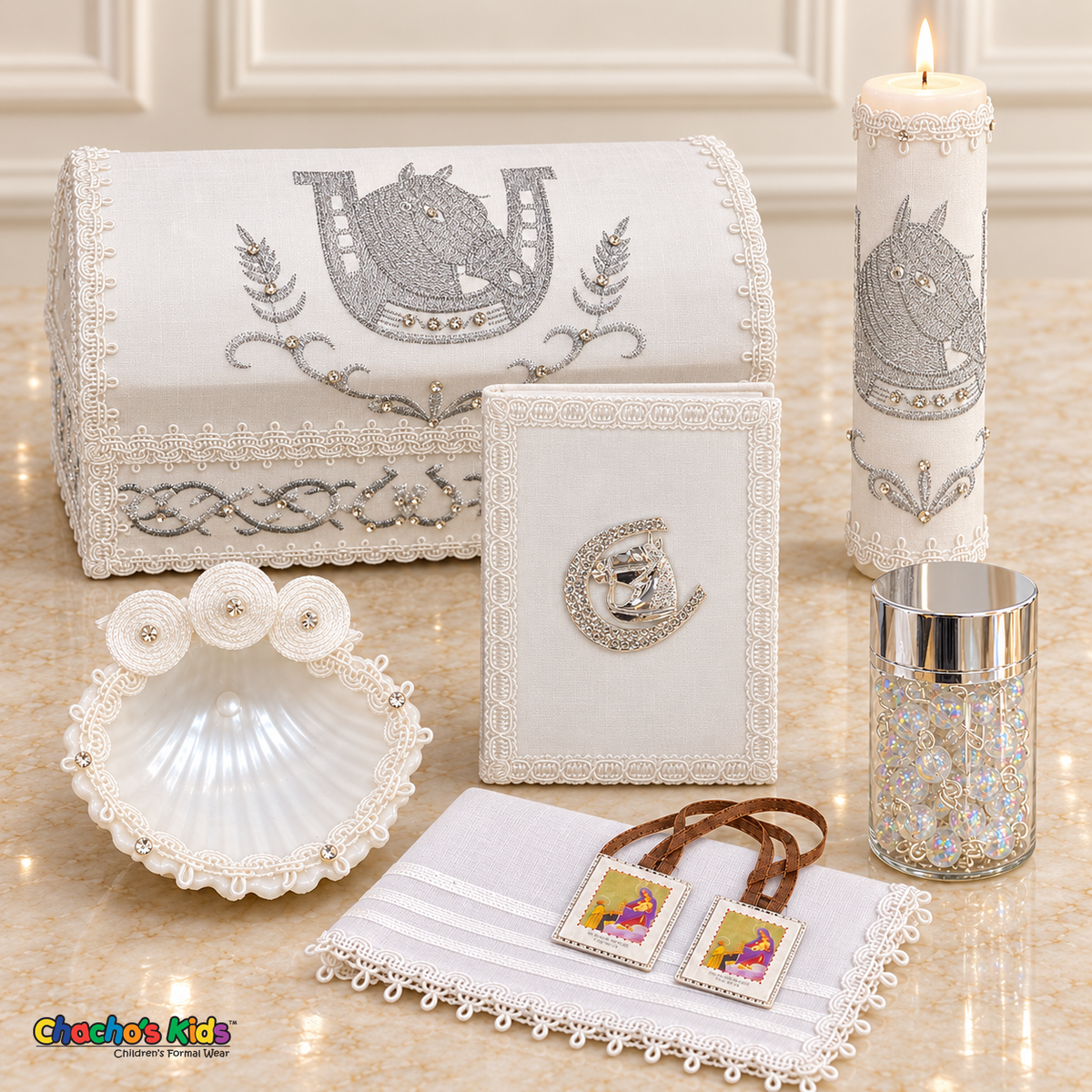 Seven-piece white and silver horse baptism set with embroidered chest, tall lit candle, matching Bible, white shell, rosary jar, handkerchief and visible scapular.