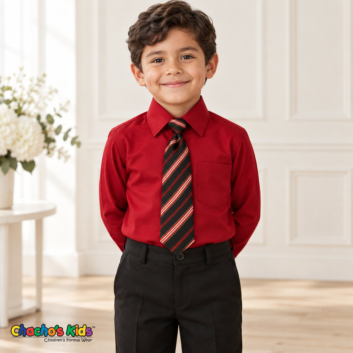 Boy wearing a classic apple red long-sleeve dress shirt with its coordinating patterned tie and black dress pants