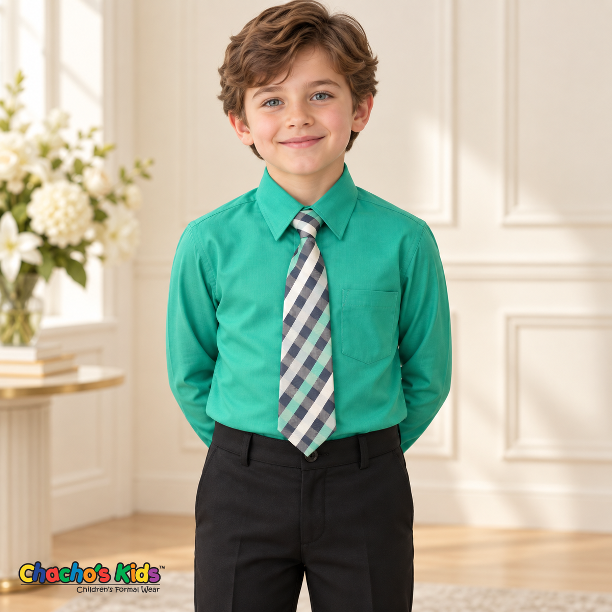 Boy wearing a classic emerald long-sleeve dress shirt with its coordinating patterned tie and black dress pants