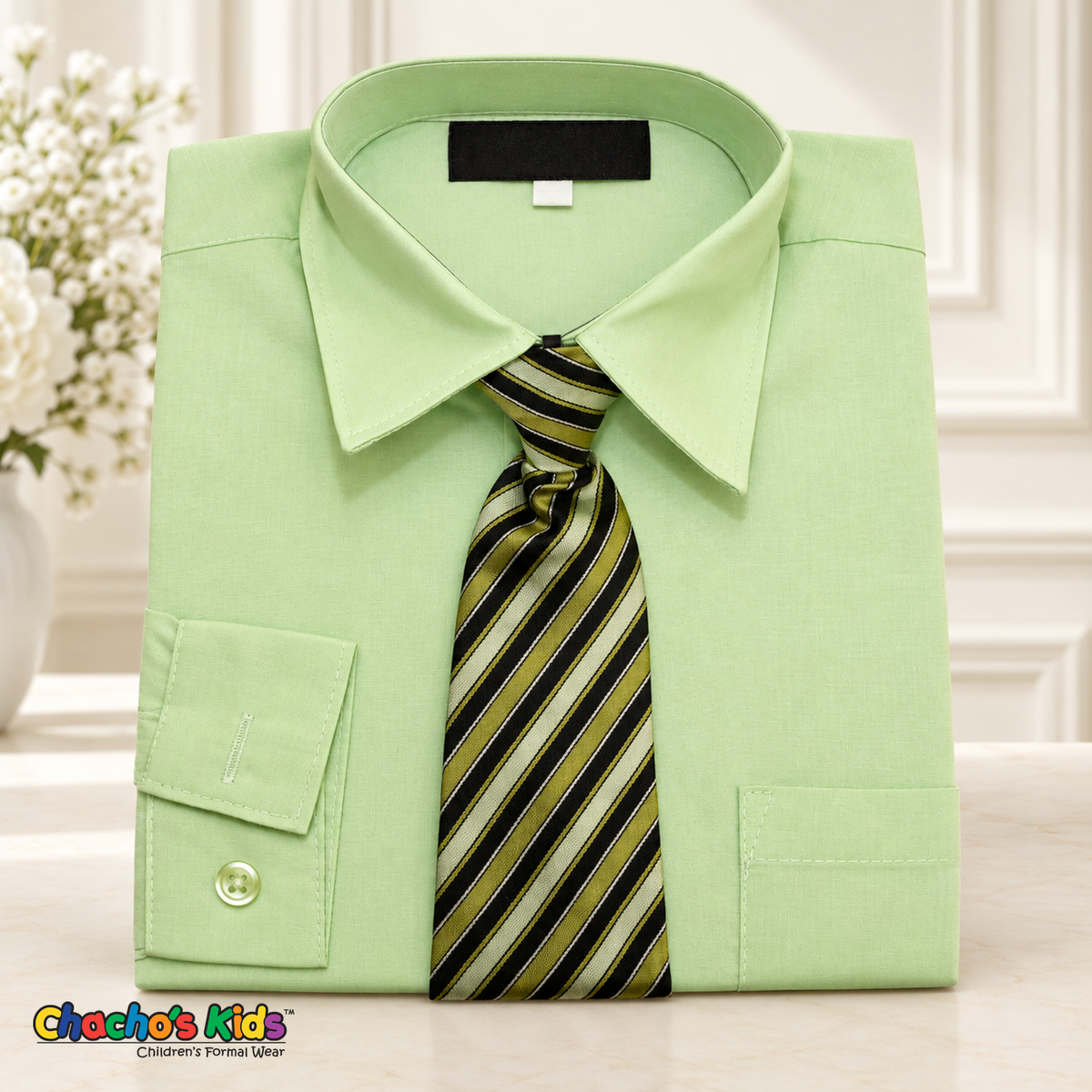 Classic pastel green dress shirt neatly folded with its coordinating patterned tie
