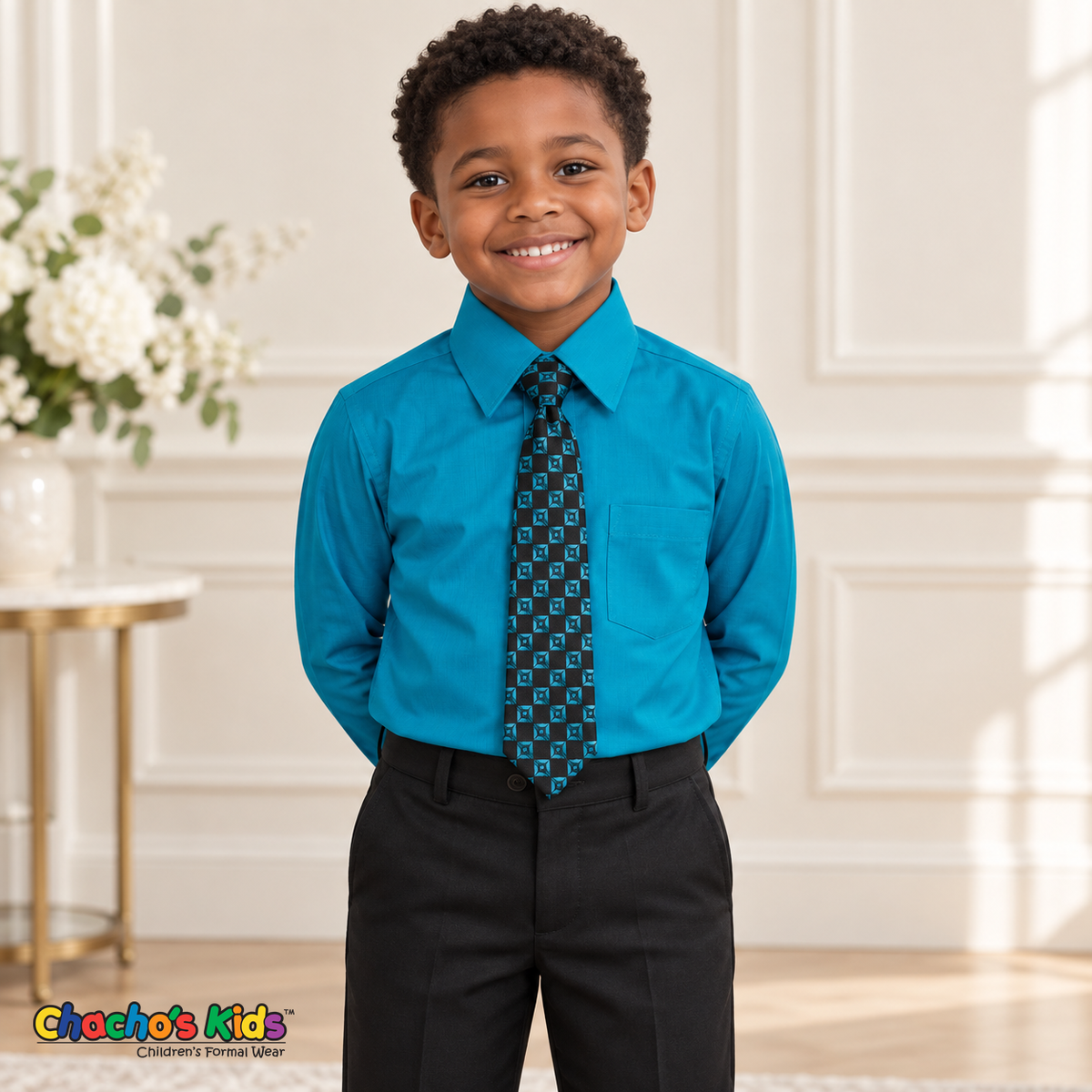 Boy wearing a classic turquoise long-sleeve dress shirt with its coordinating patterned tie and black dress pants