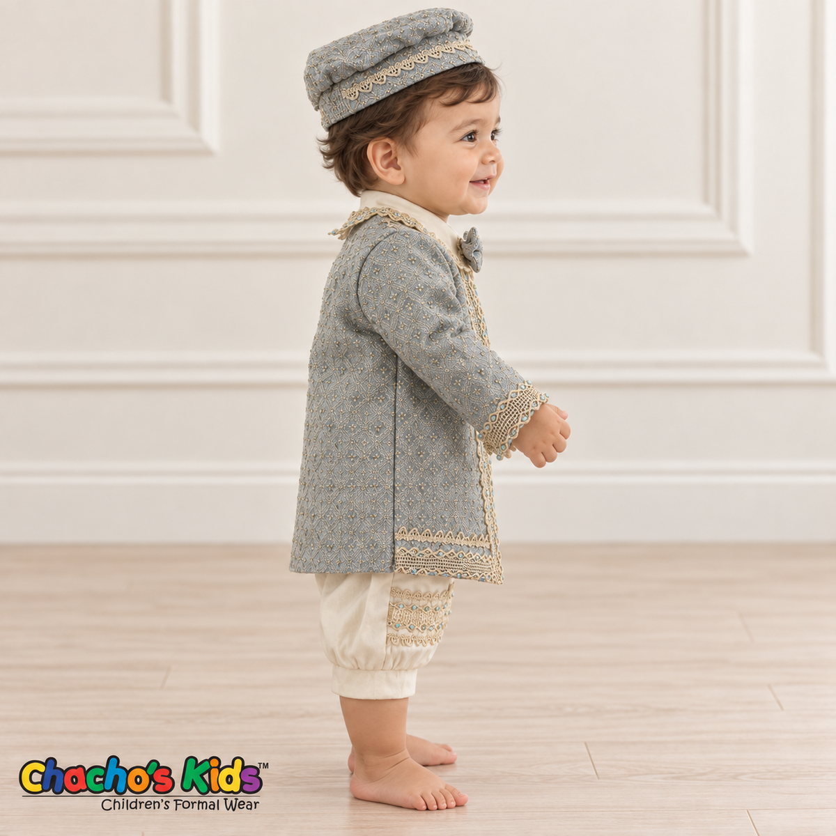 Dorian-Prince Baptism Outfit in ivory and muted blue with gold-tone trim, baby model side view with coat.