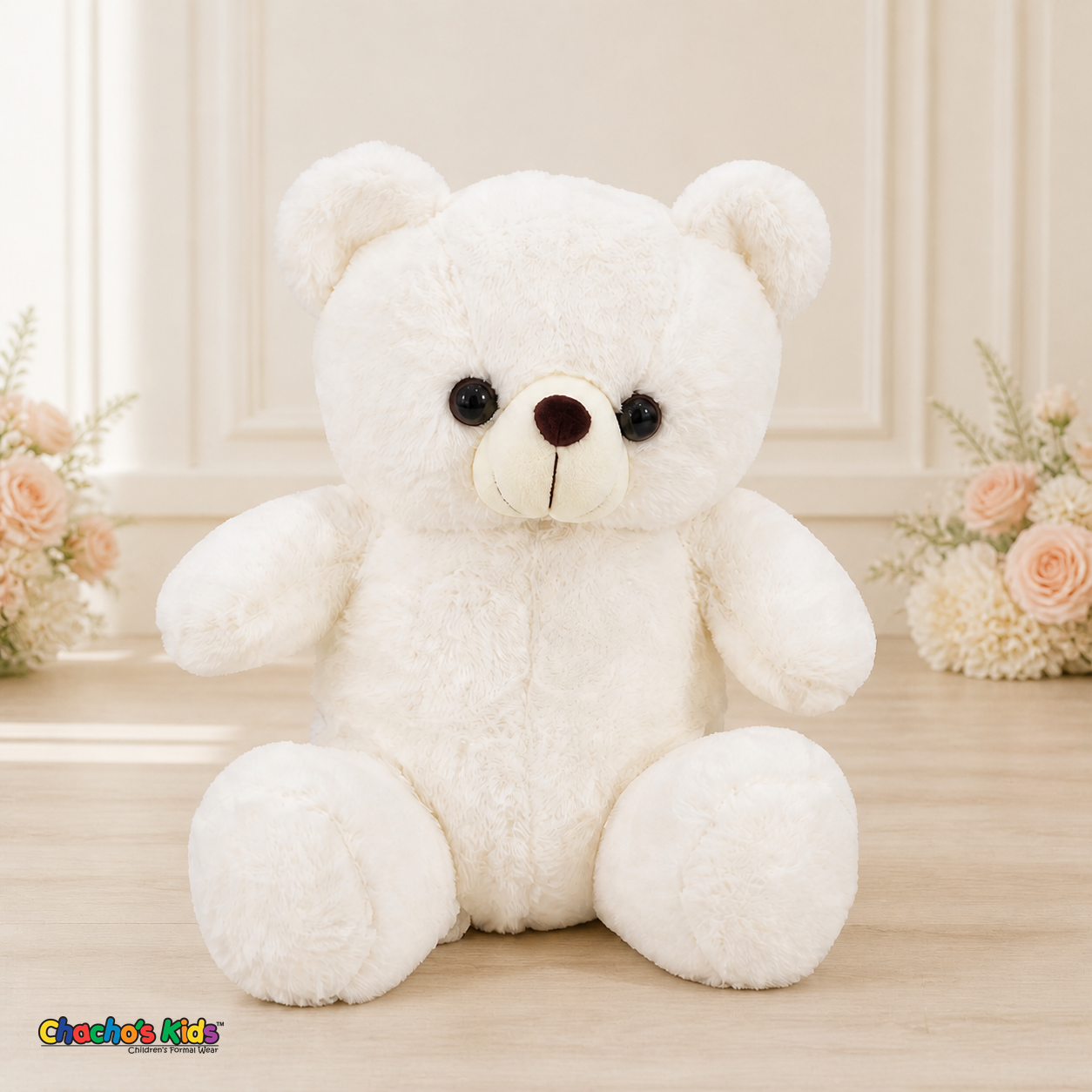 Front view of white Mini Quince teddy bear dress display in elegant cream interior with blush floral accents