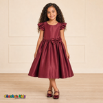 Girl wearing burgundy satin flower girl dress with bow, flutter sleeves and full skirt