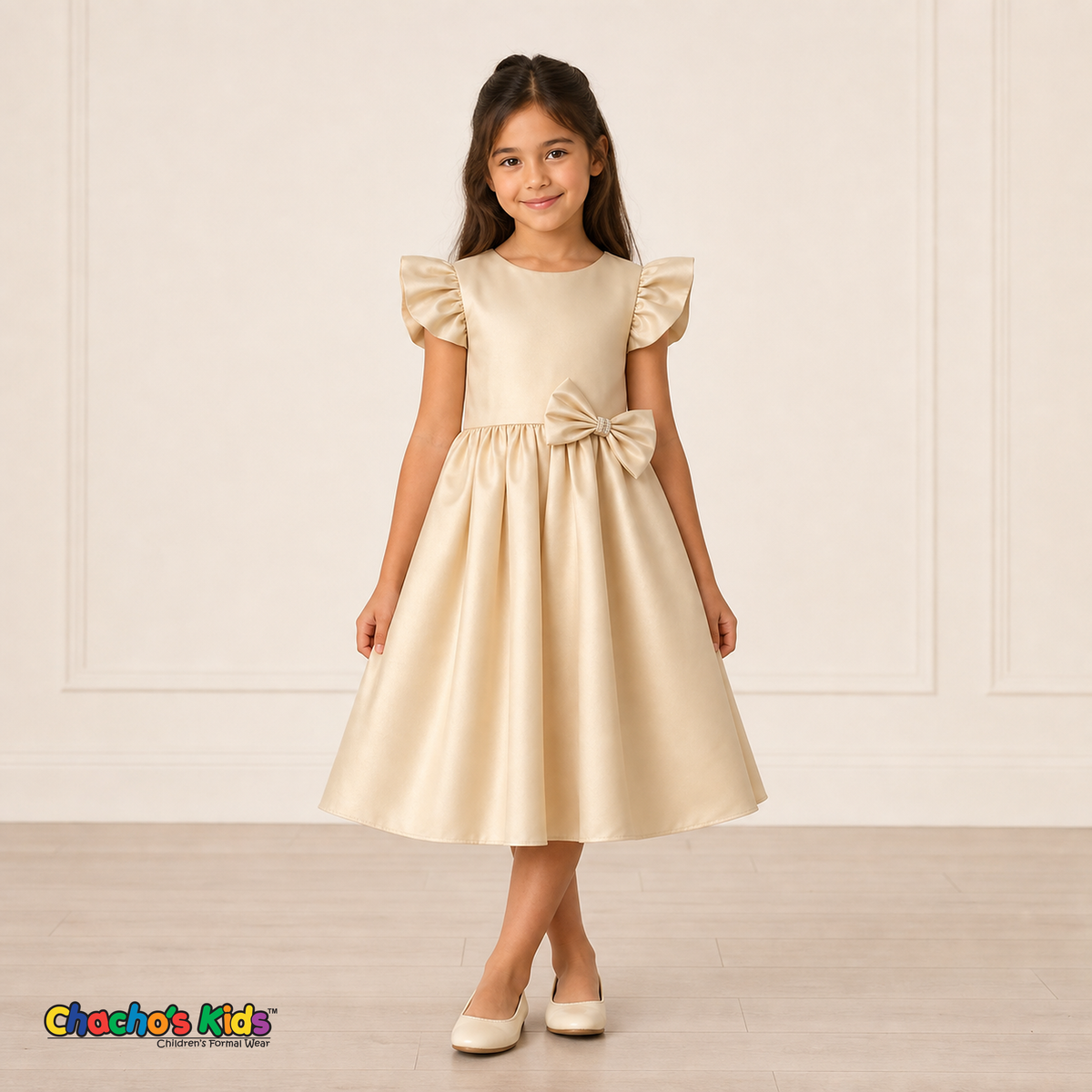 Girl wearing champagne satin flower girl dress with bow, flutter sleeves and full skirt