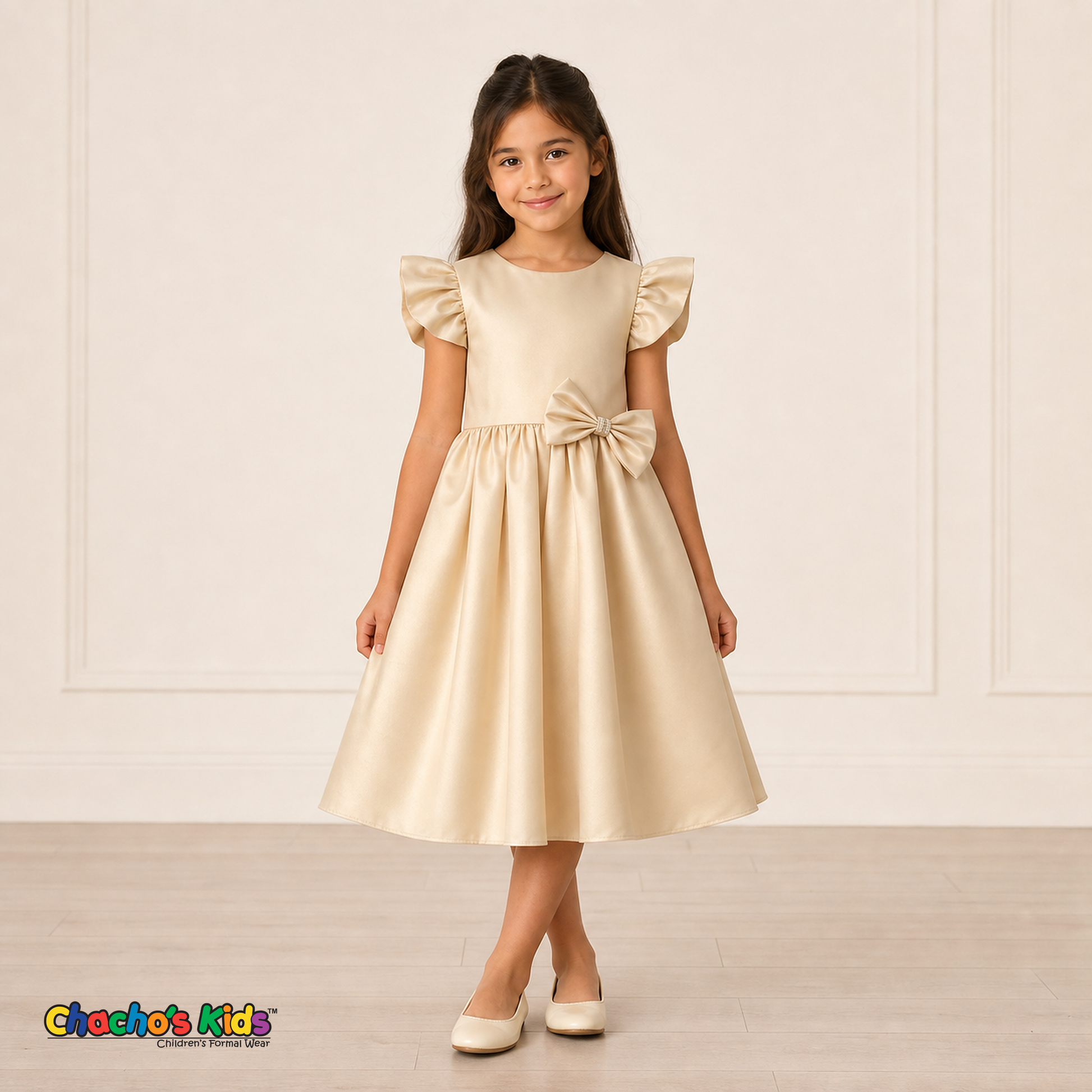 Girl wearing champagne satin flower girl dress with bow, flutter sleeves and full skirt