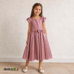 Girl wearing dusty rose satin flower girl dress with bow, flutter sleeves and full skirt