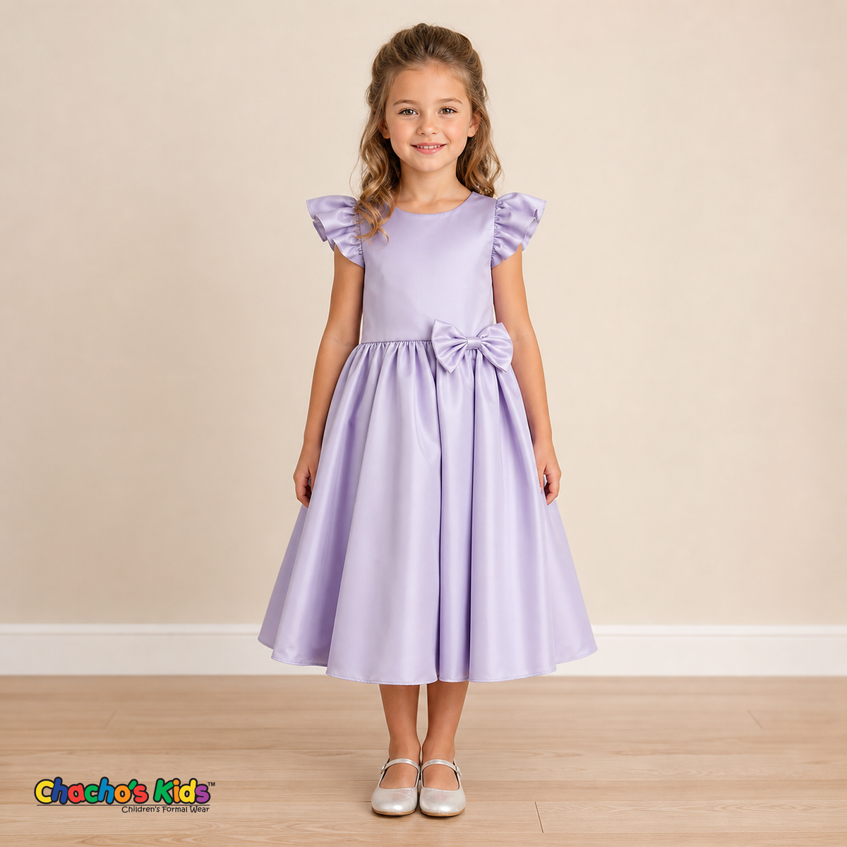 Girl wearing lilac satin flower girl dress with bow, flutter sleeves and full skirt