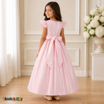 Girl wearing pink satin party and flower girl dress showing back zipper and sash bow, back view