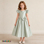 Girl wearing sage green satin flower girl dress with bow, flutter sleeves and full skirt