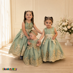 Three children modeling matching Sophie sage green gold lace tulle dresses