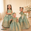 Three girls wearing Sophie sage green gold lace tulle dresses in an elegant formal setting