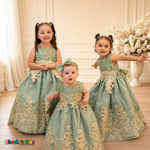 Three girls wearing Sophie sage green gold lace tulle dresses in an elegant formal setting